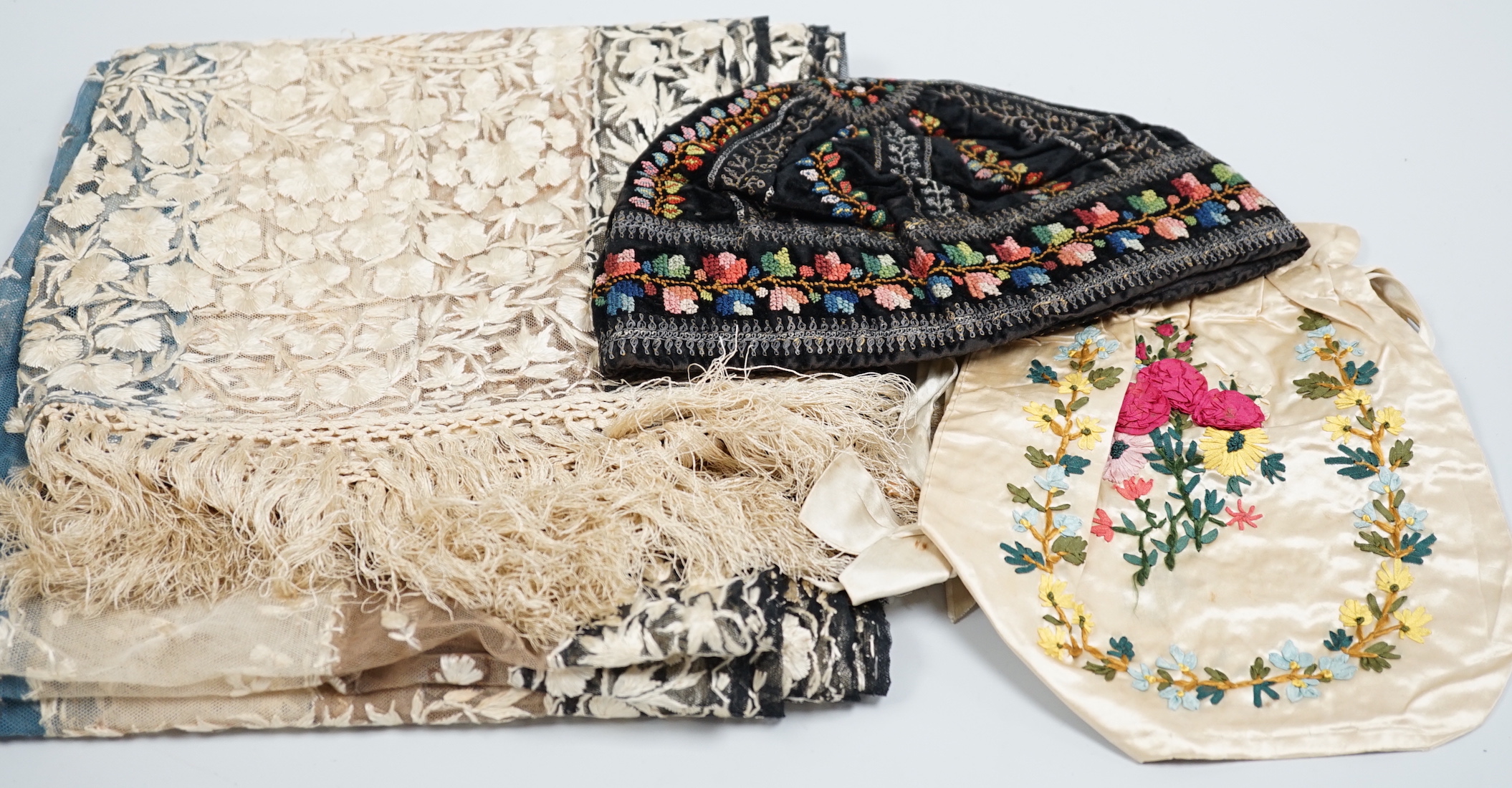 A 19th century Indian net embroidered silk floss stole, a black velvet silk cross stitch embroidered hat and a cream satin ribbon worked ladies bag, stole 240cm long, 57cm wide